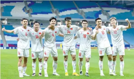  ?? Photo courtesy of VFF ?? WINNING START: Vietnamese players celebrate their 3-1 win over Kuwait in Group D of the AFC Asian U23 Cup on April 17 in Doha, Qatar.