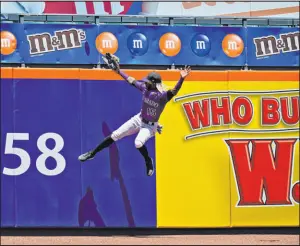  ?? Seth Wenig The Associated Press ?? Rockies left fielder Raimel Tapia pursues a ball hit by Jose Peraza for a third-inning home run Thursday in the Mets’ 1-0 win at Citi Field. Peraza drove home the go-ahead run with a fourth-inning single in the doublehead­er’s second game, won by New York 4-2.