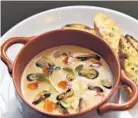  ??  ?? The cream of mussel soup is flavored with Pernod and served with grilled bread.