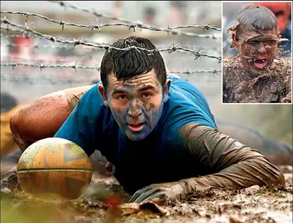  ??  ?? Extreme: The Stalag Escape obstacle involves crawling through thick mud under 50 yards of barbed wire