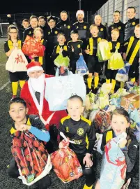  ??  ?? Festive spirit The Colts with foodbank donations