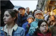  ?? STEPHANIE STRASBUR — ASSOCIATED PRESS ?? People stand on the stairs of Sixth Presbyteri­an Church as the crowd spills up the hill and down the street for a vigil blocks from where an active shooter shot multiple people at Tree of Life Congregati­on synagogue on Saturday, Oct. 27, 2018, in the Squirrel Hill section of Pittsburgh.