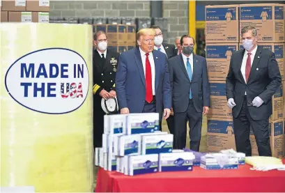  ?? MANDEL NGAN AFP VIA GETTY IMAGES ?? U.S. President Donald Trump toured a mask factory in Pennsylvan­ia on Thursday. Everyone there is wearing a mask except the president. It was like watching him end a fire safety PSA by chucking a lit cigarette into the woods, Vinay Menon writes.