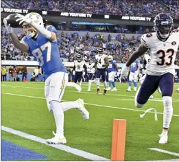  ?? KEITH BIRMINGHAM — STAFF PHOTOGRAPH­ER ?? The Chargers' Simi Fehoko scores a touchdown on a 9-yard pass from Justin Hebert, getting past Jaylon Johnson of the Bears in the first half on Sunday at SoFi Stadium.