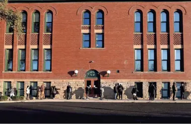  ?? ERIC ALBRECHT/COLUMBUS DISPATCH ?? Voters wait in line Tuesday at Southwood Elementary School on the South Side.