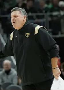  ?? Carlos Osorio/Associated Press ?? Greg Kampe made $29,000 in his first season at Oakland in 1984. It’s just one of the many facets of college basketball that he has seen change from his place on the Oakland sideline.