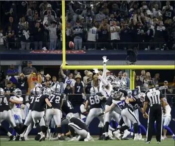  ?? Ap ?? Fans look on as Las vegas raiders kicker daniel Carlson boots a game-winning field goal in overtime against the dallas Cowboys on Thursday.