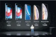  ??  ?? Phil Schiller, Apple’s senior vice president of worldwide marketing, shows off the company’s line of smartphone­s including the new top-of the-line iPhone Xs Max.