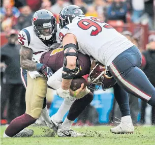  ?? MARK TENALLY THE ASSOCIATED PRESS FILE PHOTO ?? Washington quarterbac­k Alex Smith, centre, was injured as he is sacked by Houston Texans strong safety Kareem Jackson, left, and defensive end J.J. Watt in Landover, Md., last month.