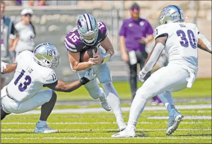  ?? Charlie Riedel The Associated Press ?? Quarterbac­k Will Howard (15) has been reasonably effective running the Kansas State offense.