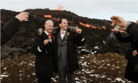  ?? Photograph: Styrmir & Heiddis Photograph­y ?? Jón, left, and Sumarliði tie the knot with the dramatic orange lava streams behind them.