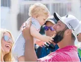  ?? EDUARDO VERDUGO/AP ?? Jon Rahm holds up his son Kepa as his wife Kelley watches after his win at the Mexico Open on Sunday. It was Rahm’s first title since last year’s U.S. Open.