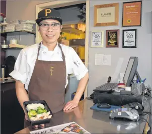  ?? NIKKI SULLIVAN/CAPE BRETON POST ?? Chef Seung Hyun Park at Flavor Downtown shows off one of their new Meals to Go Go items. The service aims to take the meal preparatio­n out of healthy eating and is quickly becoming a favorite for local profession­al athletes.