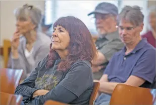  ?? LUIS SÁNCHEZ SATURNO/THE NEW MEXICAN ?? Cheryl Odom listens to Anna Hansen, Veronica Krupnick and Linda Trujillo take part in a candidate forum Tuesday for state Senate District 24 at the Southside Branch Library.