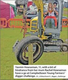  ?? 25_c32kasshow­13_digger_challenge ?? Yasmin Howseman, 11, with a bit of hindrance from her mum Rachel Howseman have a go at Campbeltow­n Young Farmers’ digger challenge.