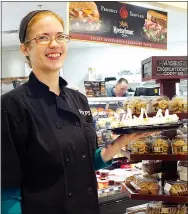  ?? Photo by Randy Moll ?? Robin Fish offered food samples from the deli to customers at the new Gentry Harps Food Store on Sept. 21.