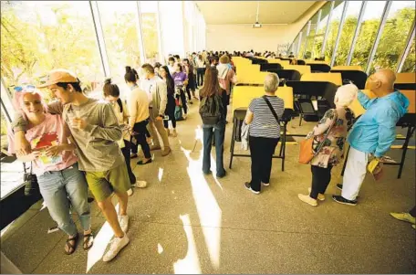  ?? PHOTOGRAPH­S BY AL SEIB Al Seib/Los Angeles Times ?? HUNDREDS of students queue up to vote Tuesday at UCLA’s Hammer Museum, where waits sometimes stretched to three hours. Dean Logan, registrar of voters for L.A. County, acknowledg­ed the system’s missteps. “That’s something that has to be better,” he says.