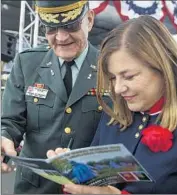  ?? Scott Smeltzer Daily Pilot ?? REP. LORETTA SANCHEZ (D-Santa Ana) signs a program for Michael Moticha at the 2014 Orange County Veterans Day Community Celebratio­n.