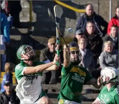  ??  ?? James Dempsey (Cloughbawn) bats the ball away from Kevin Dunne.