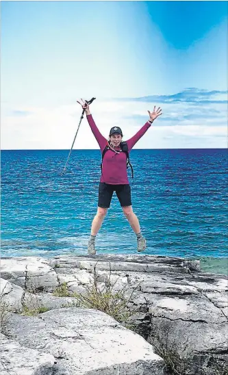  ?? SPECIAL TO METROLAND ?? Ruth Moffatt of Grimsby celebrates reaching the portion of the Bruce Trail near Tobermory on Georgian Bay.