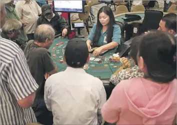  ?? Glenn Koenig Los Angeles Times ?? CARD PLAYERS try their luck at baccarat at the Gardens Casino in Hawaiian Gardens. After a $90-million overhaul, the card club has 225 tables, a restaurant and bar, plus a VIP lounge and two multiuse halls.