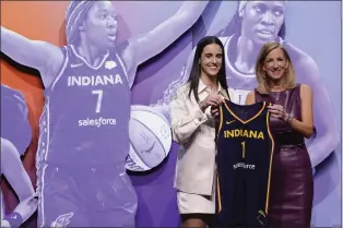  ?? ADAM HUNGER — THE ASSOCIATED PRESS ?? Iowa’s Caitlyn Clark, left, poses for a photo with WNBA commission­er Cathy Engelbert after being selected first overall by the Indiana Fever during WNBA draft Monday night in New York.