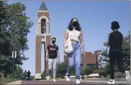  ?? MICHAEL CONROY — THE ASSOCIATED PRESS ?? Masked students walk through the campus of Ball State University in Muncie, Ind.