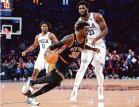  ?? John Minchillo / Associated Press ?? Knicks forward Julius Randle (30), who scored 24 points, drives past 76ers center Joel Embiid (21) during the second half in New York.