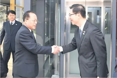  ?? Picture: AFP ?? HEARTY WELCOME. South Korean chief delegate Chun Hae-Sung, right, greets North Korean chief delegate Jon Jong-Su before their working-level talks at the border truce village of Panmunjom yesterday.