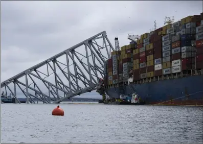  ?? (AP/The Baltimore Banner/Kaitlin Newman) ?? The Dali, a massive container ship from Singapore, still sits amid the wreckage and collapse of the Francis Scott Key Bridge in the Baltimore port early last week.