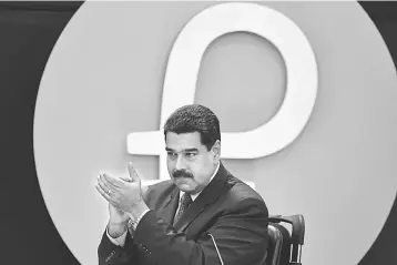  ??  ?? In this file photo Venezuela’s President Nicolas Maduro applauds during a press conference to launch a new oil-backed cryptocurr­ency called ‘Petro’. — AFP photo