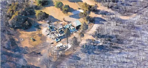  ?? DEAN HANSON/JOURNAL ?? This home, destroyed by the Dog Head Fire, is among 24 residences and more than 20 other structures lost in the wildfire burning since Tuesday.