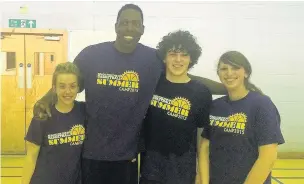  ??  ?? (Left) Aiming high Local youngsters with one of their guest visitors, at the basketball camp at Stonelaw Community Centre