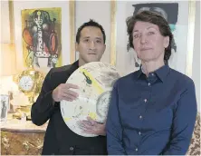  ?? THE ASSOCIATED PRESS ?? Marina Picasso, right, granddaugh­ter of artist Pablo Picasso, and her son, Florian Picasso, with a ceramic work by Pablo Picasso.