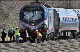  ?? MICHAEL BRYANT — THE PHILADELPH­IA INQUIRER VIA AP, FILE ?? In this April 3, 2016, file photo, Amtrak investigat­ors inspect the deadly train crash in Chester, Pa.