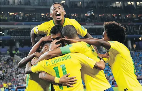  ?? KIRILL KUDRYAVTSE­V / AFP / GETTY IMAGES ?? Brazil’s players celebrate their second goal during the World Cup Group E football match between Serbia and Brazil in Moscow on Wednesday.