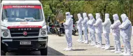  ?? PTI ?? Health workers and volunteers from SDPI wearing Personal Protective Equipment pray before carrying a body of a COVID-19 victim for burial in Chennai on Tuesday