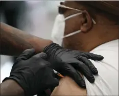  ?? AP PHOTO/JOHN LOCHER ?? David Williams receives a COVID-19 vaccine at the Martin Luther King Senior Center, Wednesday, in North Las Vegas. The makers of COVID-19 vaccines are figuring out how to tweak their recipes against worrisome virus mutations — if and when the shots need an update.