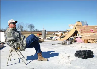  ?? (Arkansas Democrat-Gazette/Colin Murphey) ?? Randy Tune sits among the remains of his mother’s home Monday in Monette. Tune said no one was injured in the home.