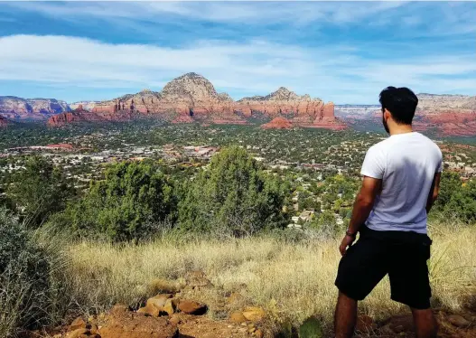  ?? REGINA DE HEER ?? Joseph Gedeon pauses on the Airport Mesa Loop to take in Sedona, the Arizona city that has long been a refuge for visitors hoping to experience its healing “vortexes.”