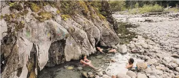  ?? DESTINATIO­N B.C./KARI MEDIG ?? Tourists soak in the lower pools at the Halfway River Hot Springs in Nakusp.