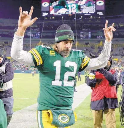  ?? GETTY ?? Aaron Rodgers exits after grabbing victory over Browns and a little bit of history Saturday in Green Bay.