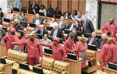  ?? PICTURE: EPA ?? PAY BACK THE MONEY: EFF members, including party leader Julius Malema, cause a stir during a question and answer session with President Jacob Zuma in Parliament. The party’s shenanigan­s are unlikely to stop in the new year, says a political analyst.