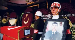  ?? Associated Press ?? Turkish soldiers stand in vigil next to the national flag-draped coffin of Ali Kalo.