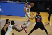  ?? JEFF CHIU — THE ASSOCIATED PRESS ?? Warriors guard Stephen Curry passes the ball against Toronto Raptors forward Yuta Watanabe on Sunday.