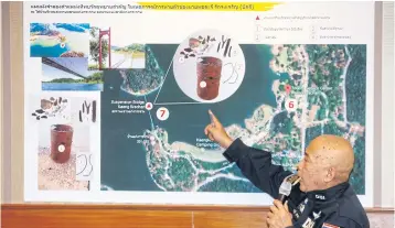  ?? PORNPROM SATRABHAYA ?? DSI deputy director-general Korrawat Panpraphak­orn points at the location where an oil barrel containing bone fragments was found in Phetchabur­i’s Kaeng Krachan National Park.
