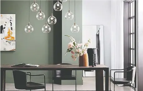  ?? CB2.CA ?? Deep grey and black colours help olive green to shine as a splash of colour in a modern dining room setting.