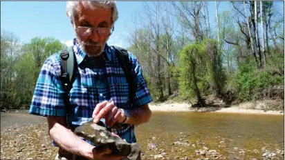  ?? Washington Post photo by Monica Akhtar ?? Ray Stanford examines a rock for traces of ancient dinosaurs.