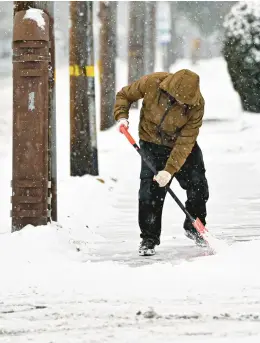  ?? APRIL GAMIZ/THE MORNING CALL ?? Ravi Singh shovels a sidewalk in the snow on Jan. 16 in Bethlehem. Heavy snow is expected in the Lehigh Valley on Tuesday morning, continuing into the afternoon, in a storm that could bring as much as 5-8 inches of snow to the area.