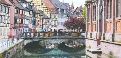  ?? CAMERON HEWITT/RICK STEVES' EUROPE ?? Colourful half-timbered houses line canals in Colmar, a vivid French town with German flair in Alsace.